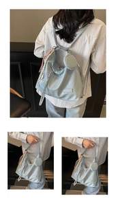 Detail of light blue glossy tote bag with dual-use straps and small round pouch
