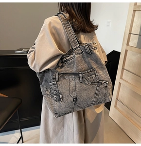 Detailed back view of a grey washed denim tote bag featuring creative jean pocket design