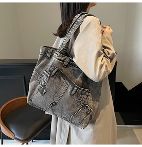 Detailed view of vintage washed denim tote bag featuring jeans pocket and belt loop accents