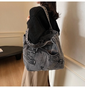 Side view of large charcoal denim tote bag with vintage jeans-style pockets and stitching
