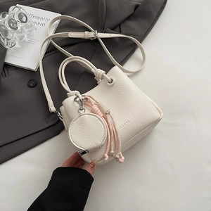Minimalist off-white litchi grain leather bucket bag with braided rope and coin purse