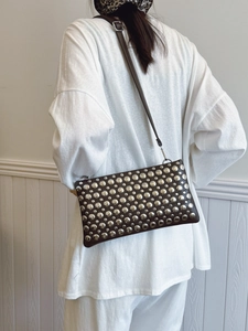 Brown retro punk style shoulder bag with silver rivet studs and adjustable strap