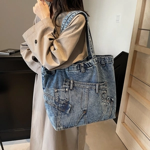 Retro denim tote bag featuring vintage patchwork design and wide shoulder strap for daily use