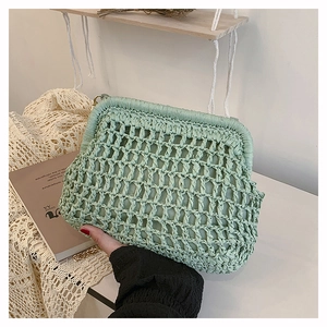 Detail of light green woven cloud bag showing texture, metal frame and soft lining
