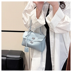 Mirror selfie showing the light blue leather tote bag with silver turn-lock and tassel detail