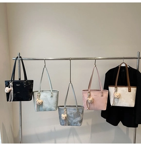 Collection of tote bags in five colors with mini metal logo and plush bear charms