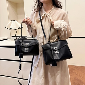 Minimalist black matte leather tote bag in two sizes with silver twist lock and strap