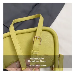 Detail of adjustable shoulder strap with gold buckle on yellow leather tote bag