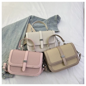 Three elegant woven handbags in pink, white, and khaki colors with metallic buckles