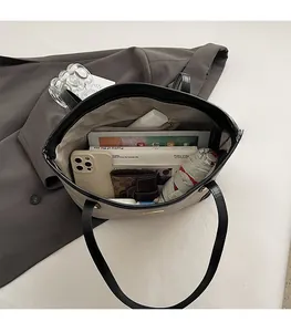 Spacious interior of a contrast tote bag showing storage for tablet and daily essentials