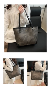 Detail view of large tote bag featuring gray marble texture and black strap accents
