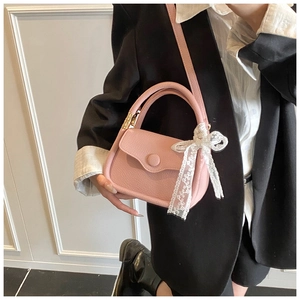 Pink lychee textured square crossbody bag with silk lace bow and adjustable strap