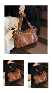 Detailed close-up of brown vintage tote bag with metal rivets and leather texture