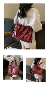 Detail of burgundy PU leather tote bag with glossy finish and soft textured folds