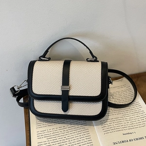 Elegant ivory woven small square bag with black leather trim and silver metal clasp