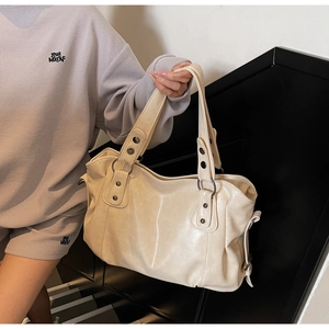 Detailed texture of creamy white PU leather tote bag with elegant pleated side details