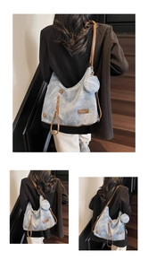 Detail of vintage tote bag with light blue fabric, brown straps and round coin purse