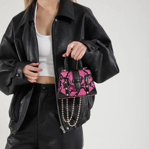 Pink and black snake pattern mini handbag with gold rivets and chain fringe detail