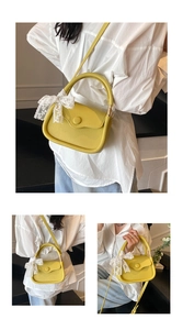 Detail of yellow lychee pattern handbag featuring a white lace bow on the handle