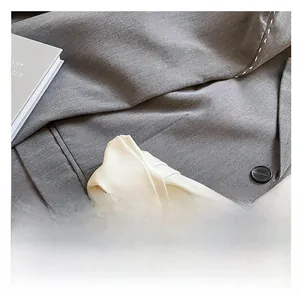 Close-up of the stylish white knotted leather handle on a designer underarm bag