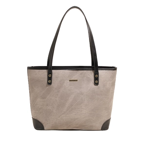 Minimalist grey suede and black leather tote bag with elegant golden hardware accents