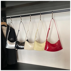 Detailed display of semi-circle patent leather bags in silver, black, beige, yellow, and red