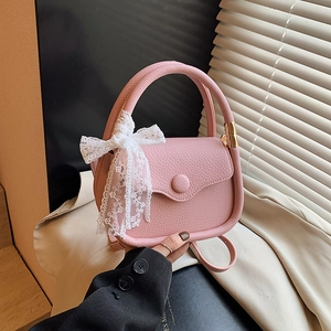 Pink lychee texture crossbody handbag with white lace bow and adjustable strap