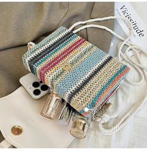 Detail showing the inner capacity of this colorful striped woven straw shoulder bag
