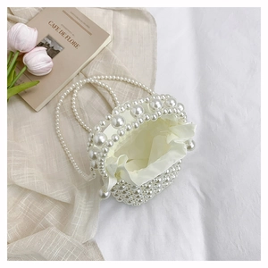 Top view of pearl woven bucket bag with silk drawstring liner and elegant handle