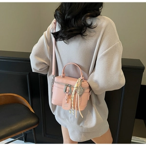 Pink box crossbody bag with textured leather, double zippers and silk scarf detail