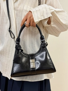 Chic black glossy pleated dumpling bag with silver buckle for elegant women