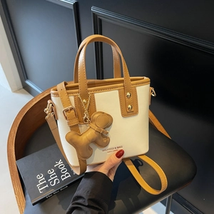 Chic cream and brown bucket bag with teddy bear charm for women's daily commute