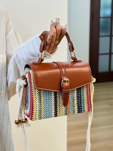 Bohemian striped straw woven bag with brown leather handles and side cotton tassels