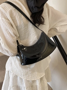 Glossy black patent leather crescent shoulder bag with NO FILTER print for women