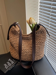 Lazy style handwoven straw shoulder bag with adjustable brown leather straps and tulip