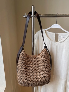 Brown woven straw hobo bag with adjustable leather shoulder strap for beach vacation