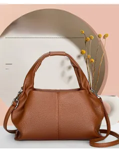 Close-up of brown litchi pattern leather handbag with silver hook and stitching details