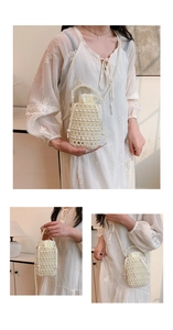 Detailed views of a white pearl beaded bucket bag with drawstring satin interior and chain