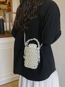 Elegant white faux pearl woven bucket bag with drawstring pouch for stylish women