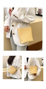 Detail of light yellow lychee pattern leather texture on stylish crossbody bucket bag