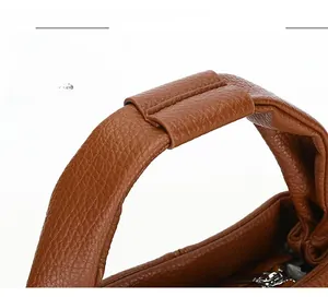 Close-up of comfortable lychee texture leather handle on a brown dumpling handbag