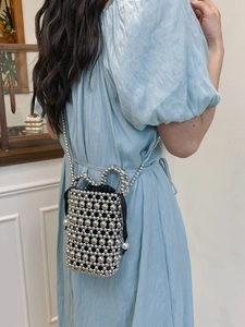 Chic silver beaded mini bucket bag with black drawstring liner and pearl accents