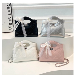 Group shot of quilted chain bags in black, silver, white and pink with lace bow detail