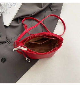Detailed interior view of red lychee leather bucket bag with zipper and lining