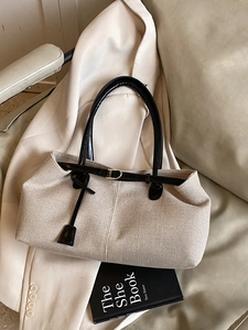 Contrast beige woven tote bag with black leather handles for commuter daily casual wear