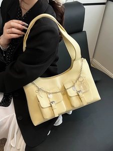Minimalist pale yellow waxed leather tote bag with multi-pockets and silver chain detail