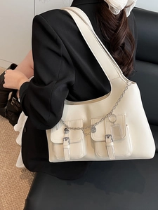 White faux leather tote bag with dual front pockets and silver chain for stylish commuting