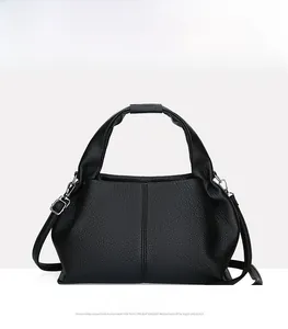 Detail of black cloud-style handbag with lychee pattern leather and silver hardware