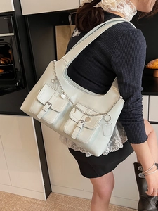 Mint green oil wax leather tote bag with functional pockets and heart chain strap