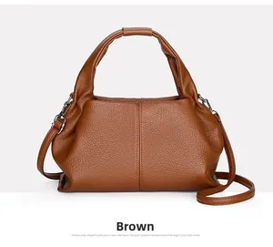 Detailed view of brown cloud bag with lychee grain texture and silver metal buckles